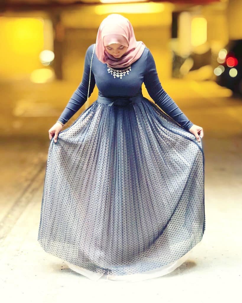 Laaiqah in a navy dotted tulle skirt and pink headscarf